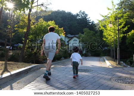 The look of a father and son walking together. And a family photo of each other resembling each other.