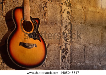 The guitar placed on the wall Cold light hits
