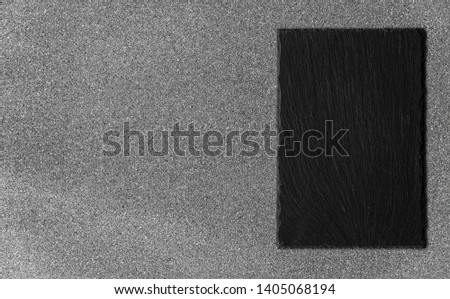 Background of grey stone texture and pattern with black slate piece for food and product photography