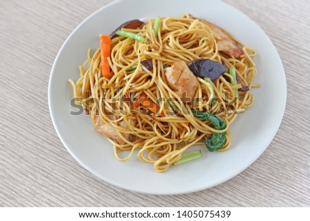 asian fried noodle with vegetable on white dish