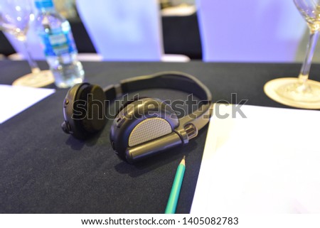 Royalty high quality free stock photo Closeup of unknown brand interpreter's headset. Photo in a seminar of cryptocurrency investment