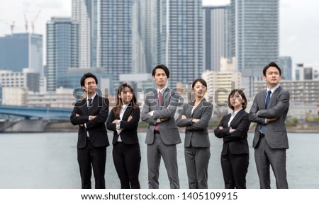 Group of businessperson lining up in front of the city.