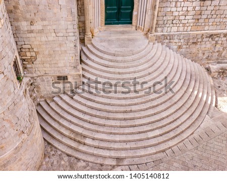 High angle view of the medieval semi circular stone staircase outside the entrance to the Dominican Monastery in the Old Town of Dubrovnik, Croatia.