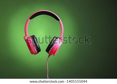 Stylish headphones on color background. Space for text