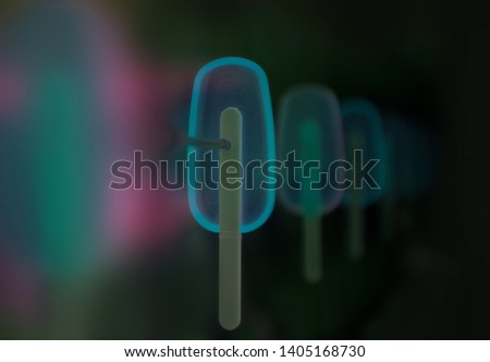 Blue neon candies (lollipops) in the vending machine. Sweet candy in black background space