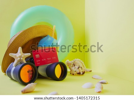Travel plan concept, Composition traveler summer  vacations accessories retro binoculars ,Red Credit card and starfish  summertime on bright yellow wall background. copy space for banner