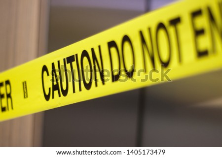 Caution do not enter yellow tape across elevator doors close up