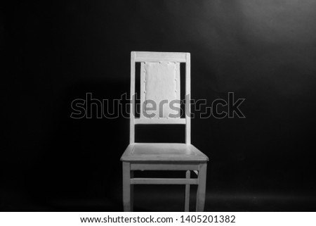 White chair on the black background