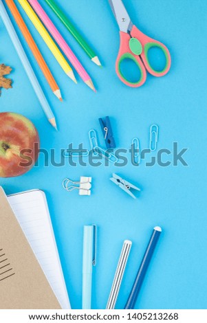 Creative flat lay top view back to school concept with color school and office supplies on bright turquoise paper table frame background with copy space, template for text or design