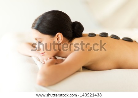 picture of woman in spa salon with hot stones Royalty-Free Stock Photo #140521438