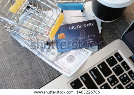 Top office wood table with cup of money credit card and cart cart trolley and copy space ,Business, accounting and payment concept financial information isolated on a modern marble office table,