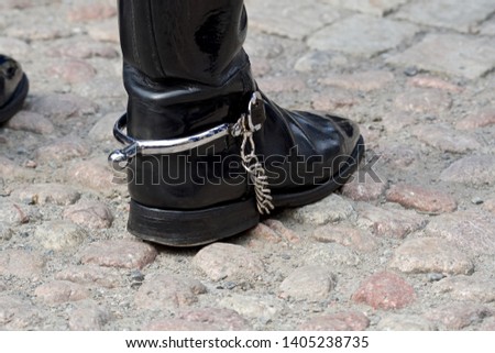 Street photo of leather boot with spur.