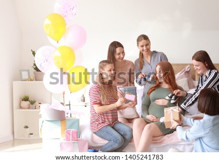 Beautiful pregnant woman and her friends at baby shower party Royalty-Free Stock Photo #1405241783