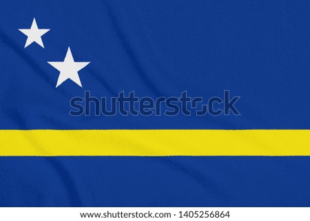 Flag of Curacao on textured fabric. Patriotic symbol
