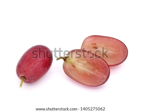Macro picture of whole fresh red seedless grape and cut half pieces isolated on white background.