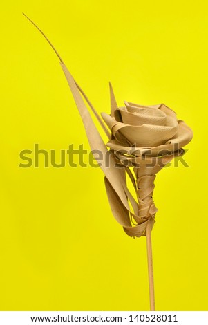 Closeup Of A Handwoven Bamboo Rose On Golden Yellow Background