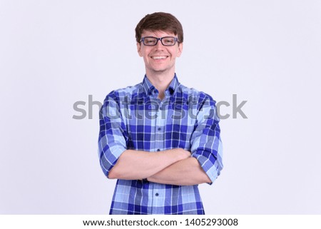 Happy young handsome hipster man smiling with arms crossed