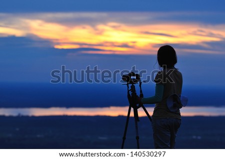 Women Nature photographer  with digital camera on the mountain