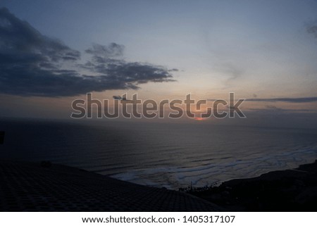 sunset at the ocean or beach , view from the hill