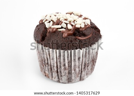 Tasty chocolate cupcakes on white background. Chocolate caramel cupcake and butterscotch syrup. Chocolate cupcake isolated on white.