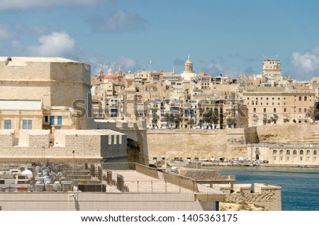 View to Valetta's harbor and old town with a dome of  St. Paul's Pro-Cathedral seen from St. Angelo fort in Vittoriosa, Malta