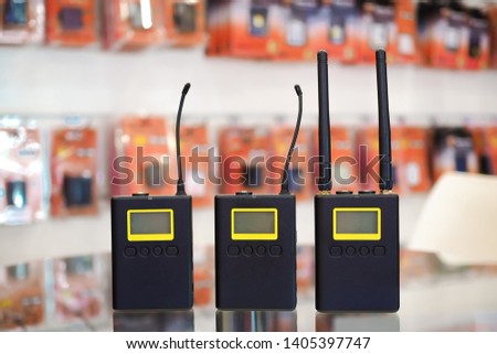 Wireless microphone transmitter for digital camera blurred background.
