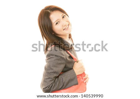 Smiling young woman holding a shoulder bag