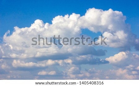 Simple beautiful gloomy blue sky with fluffy clouds in summer morning peace day as a background. Gray, white and turquoise color blurred skyline texture photography
