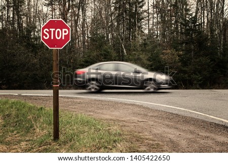 Stop sign and blurred car. Danger of accident  concept.