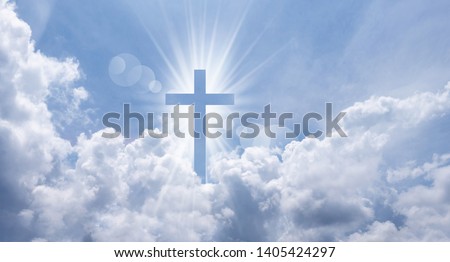 Christian cross appears bright in the sky background