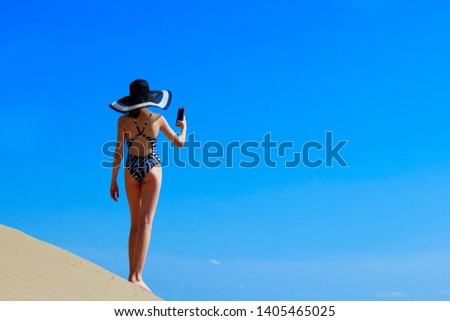 Young Girl Standing On The Top Of Mountain And Taking A Picture of Beautiful Landscape. People, Travel, Instagram Concept. Young Pretty Woman Standing on the edge of the Earth, fantasy concept. 