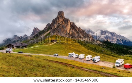 Beautiful Nature Italy natural landscape. Wonderful mountains scenery in Dolomites Alps during sunset. Great view of Passo Giau. Vacation with an caravan on road in mountains. Traveling concept. 