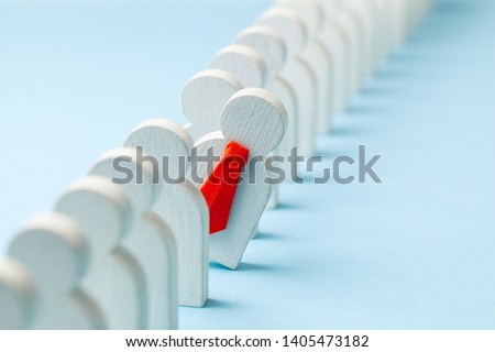 Staff recruitment. Headhunting. Many employees and the choice of a leader from the crowd. HR. A lot of white businessman and one in a red tie on a blue background. Royalty-Free Stock Photo #1405473182