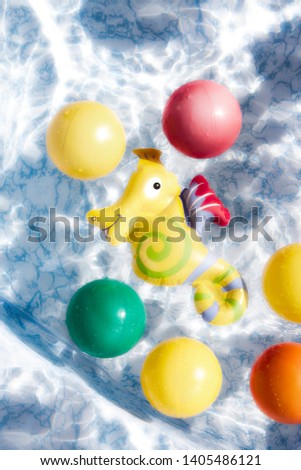 Colorful balls floating in the water of the pool. Summer. Holidays. Royalty-Free Stock Photo #1405486121