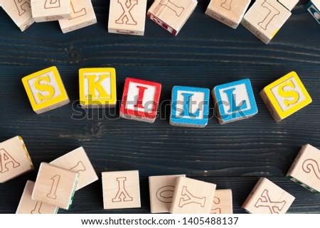 Alphabet blocks ABC on wooden table. Text - skills