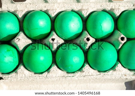 Boiled green eggs in a package. Easter holiday top view.

