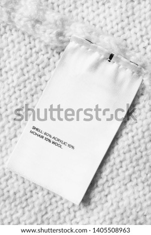 Fabric composition clothes label on white knitted background