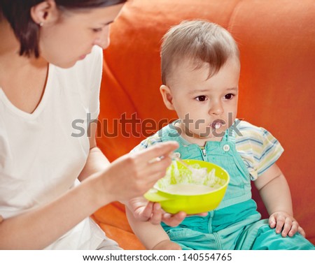 young mother feeding her infant