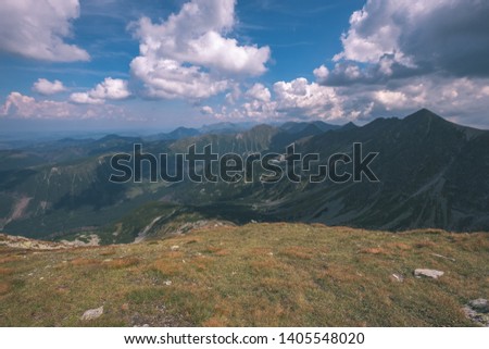 rocky mountain tops with hiking trails in autumn in Slovakian Tatra western Carpathian with blue sky. Empty rocks in bright daylight, far horizon for adventures. - vintage old film look
