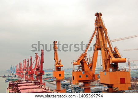 Cargo terminal for unloading grain cargo and containers by shore cranes. Port Guangzhou, China. February, 2019.