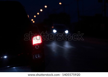 Blurred image of Cars on the road in traffic junction at night.