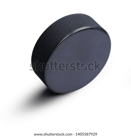  A Ice hockey Black rubber hockey puck  in upright position with copy space isolated on white background for sports design. This has clipping path.                                