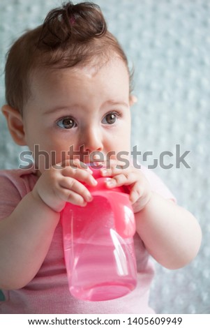 portrait of feeding baby drinking bottle water