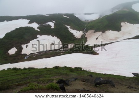 This is a mineral hot springs in the southern part of the Kamchatka - active fumarole field whose hot gases pass through the water of a cold stream, heating it and creating a spouting effect.
