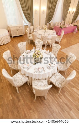 
Wedding light table with flowers. Hall of the restaurant.