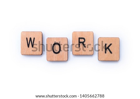 The word WORK, spelt with wooden letter tiles over a plain white background. 