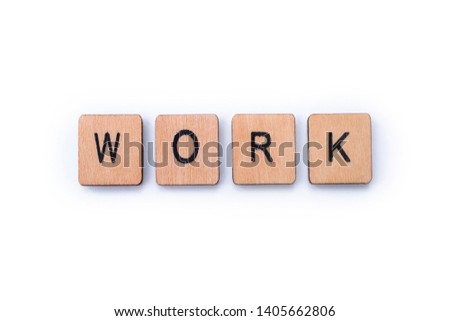 The word WORK, spelt with wooden letter tiles over a plain white background. 