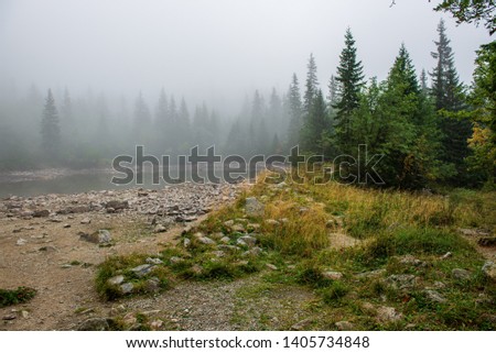 slovakia Tatra mountain lakes in misty weather in summer with mountain reflections in calm water