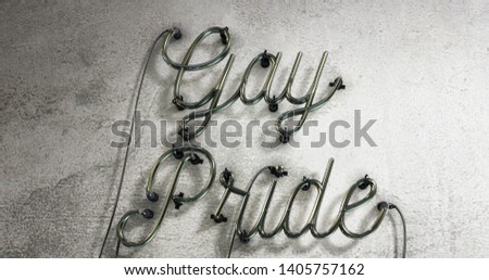 Turned off neon sign that says Gay Pride on a grey concrete wall background.