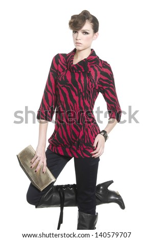 fashion style young woman holding purse with boots posing in studio